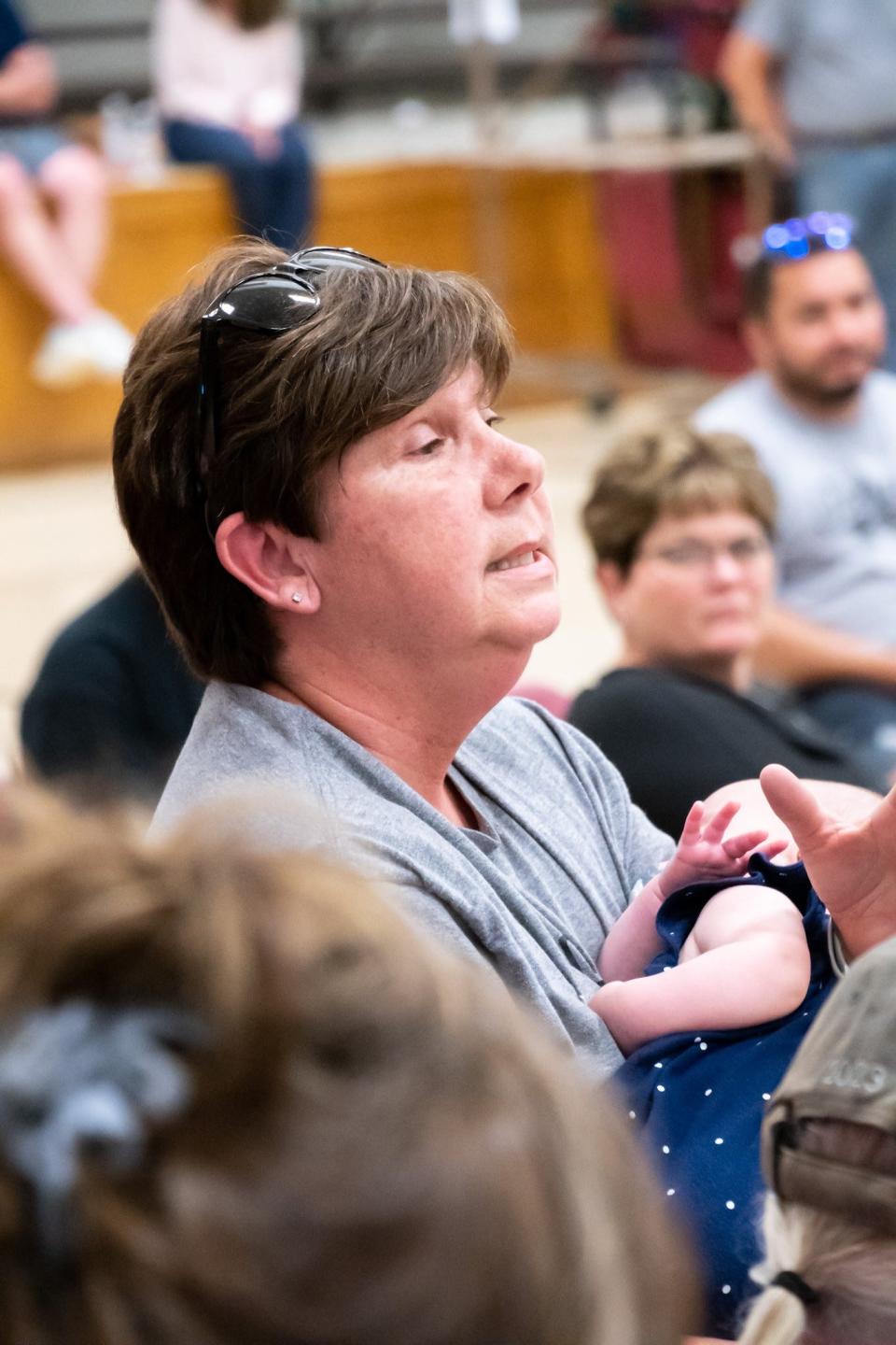 Sherri Saling, an East Muskingum School bus driver, speaks to the crowd during the meeting.