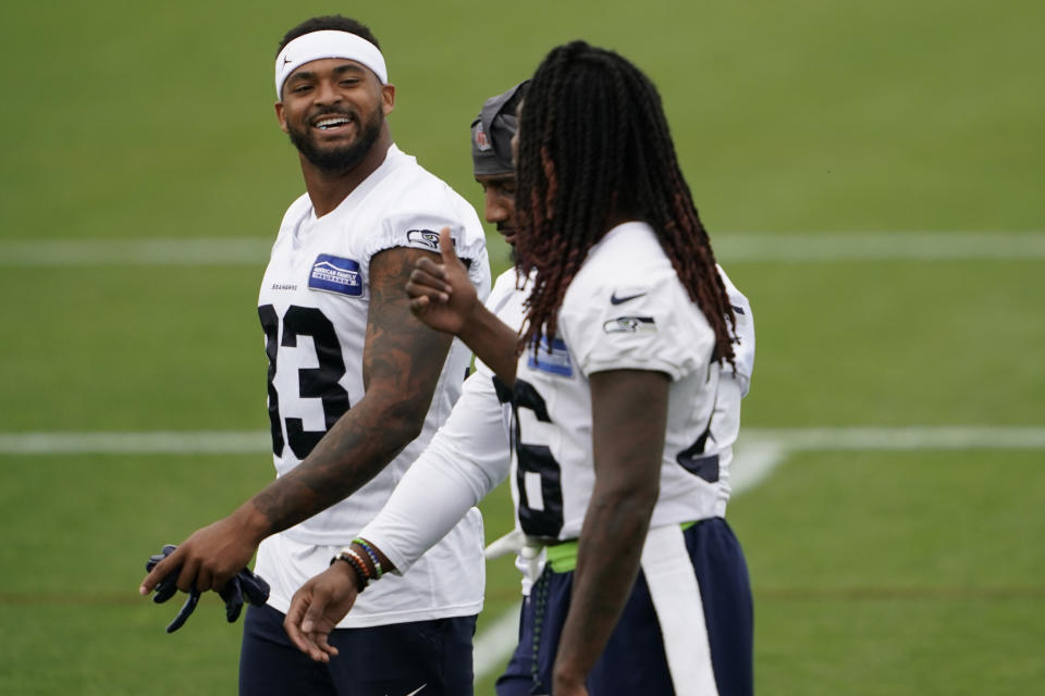 Seattle Seahawks safety Jamal Adams, left, talks with teammates Shaquill Griffin, right, and Quandre Diggs, center during NFL football training camp, Thursday, Aug. 20, 2020, in Renton, Wash. (AP Photo/Ted S. Warren)