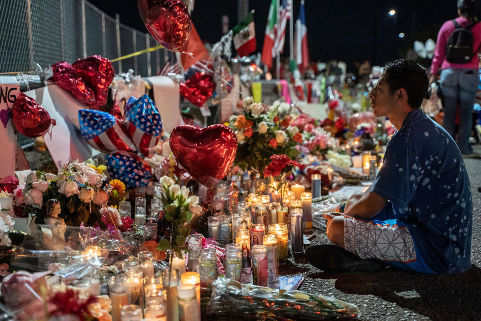 Abel Valenzuela meditates in front of the makeshift memorial for shooting victims at the Cielo Vista Mall Walmart in El Paso, Texas on August 8, 2019. | Paul Ratje—AFP via Getty Images