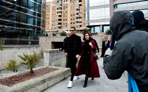 Cristiano Ronaldo leaves with his Spanish girlfriend Georgina Rodriguez after attending a court hearing - Credit: OSCAR DEL POZO/AFP/Getty Images