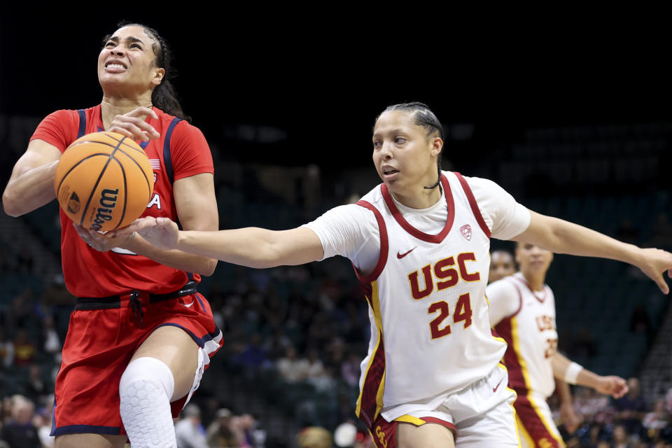 Southern California forward Kaitlyn Davis (24) attempts to steal the ball from Arizona forward Esmery Martinez, left, during the first half of an NCAA college basketball game in the quarterfinal round of the Pac-12 tournament Thursday, March 7, 2024, in Las Vegas. (AP Photo/Ian Maule)