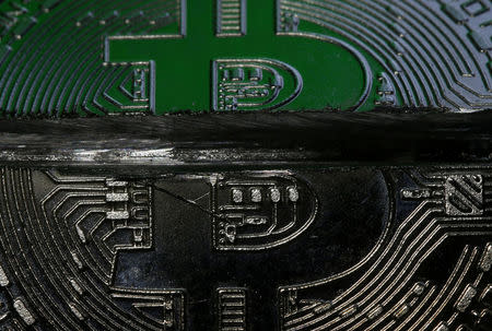 A sawed Bitcoin token representing the virtual currency is seen in this illustration picture, December 8, 2017. Picture taken December 8, 2017. REUTERS/Dado Ruvic/Illustration