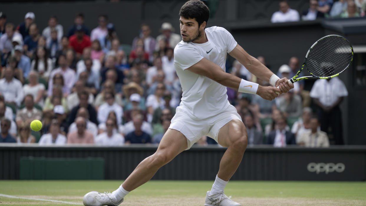  Carlos Alcaraz winds up a backhand return at Wimbledon 