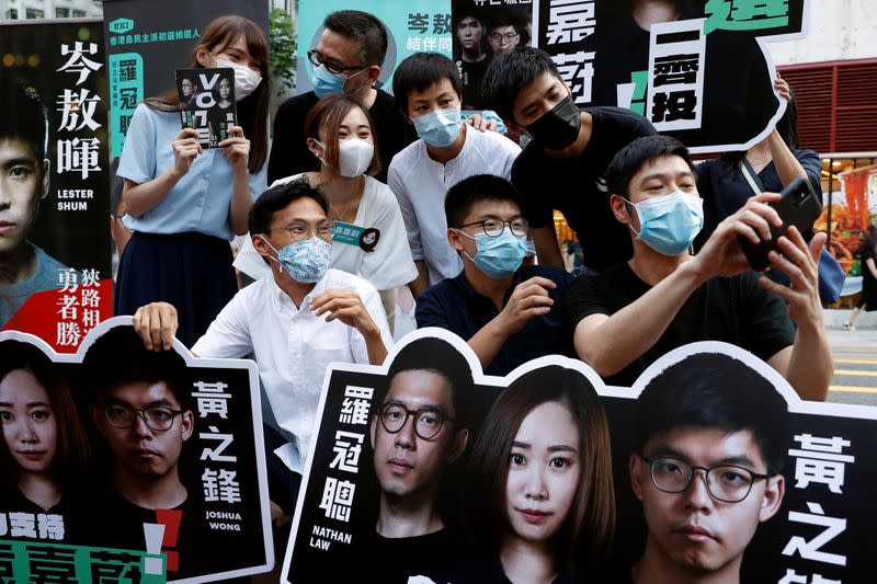 Agnes Chow, Anthony Wong Yiu Ming, Tiffany Yuen Ka-wai, Denise Ho Wan See, Lester Shum, Eddie Chu, Joshua Wong and Gregory Wong pose for photo at a campaigning during primary elections aimed for selecting democracy candidates, in Hong Kong