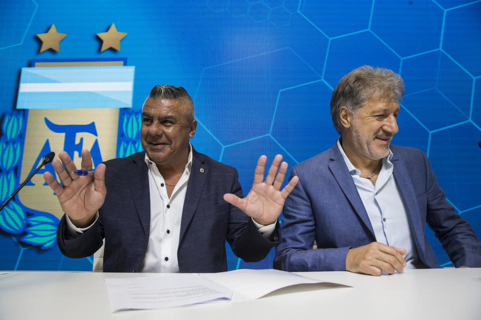 Claudio Tapia, president of Argentina's Soccer Federation, left, and General Secretary of the Argentina's Footballers' Union (FAA) Sergio Marchi, take part in a press conference to announce the early implementation of a plan to professionalize women's soccer in Buenos Aires, Argentina, Saturday, March 16, 2019. Almost 90 years after men's soccer turned professional in Argentina, the women's game is still being played by amateur athletes who get little to no money for their work on the field. (AP Photo/Daniel Jayo)