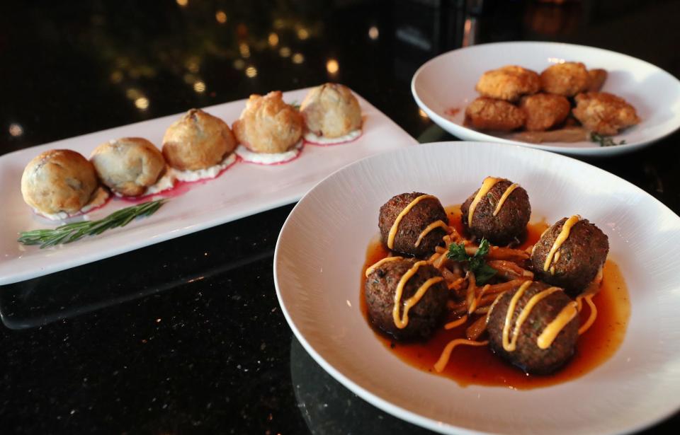 A trio of small plates - from left, wellington bites, wasabi falafel and chicken fritters - at the new restaurant and bar The Circle of 5ths, located above Blue Jazz+ in Akron.