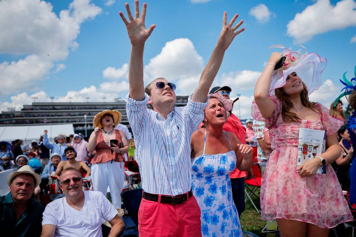 Spectators cheer during the eighth race of the day at Churchill Downs on Kentucky Derby Day.