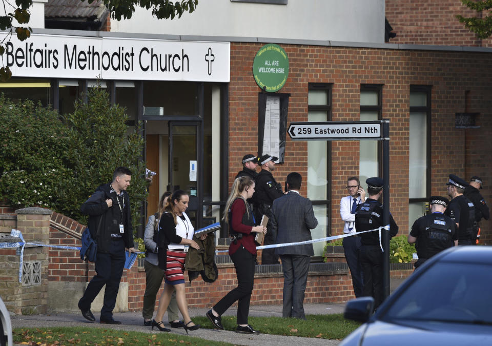 People leave the Belfairs Methodist Church in Eastwood Road North, where Conservative MP Sir David Amess has reportedly been stabbed several times at a constituency surgery, in Leigh-on-Sea, Essex, England, Friday, Oct. 15, 2021. British police say a man has been arrested after a reported stabbing in eastern England. News outlets say the victim is Conservative lawmaker David Amess. The Essex Police force said officers were called to reports of a stabbing in Leigh-on-Sea just after noon Friday. It said “a man was arrested shortly after & we’re not looking for anyone else.” (Nick Ansell/PA via AP)