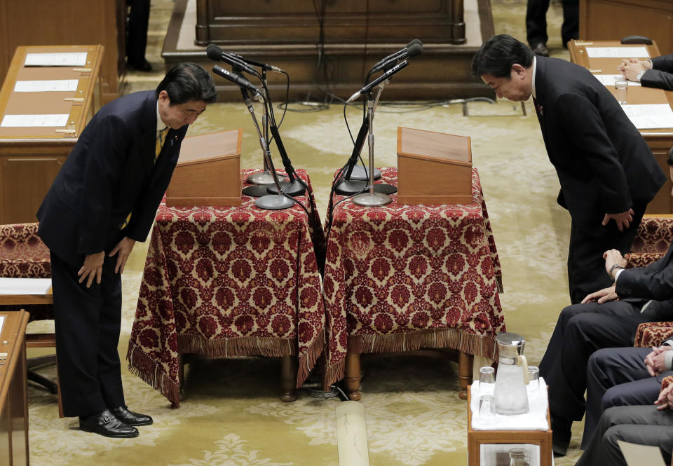 Japanese Prime Minister Yoshiko Noda, right, and Japan's main opposition Liberal Democratic Party President Shinzo Abe bow at each other before their debate at Parliament in Tokyo Wednesday, Nov. 14, 2012. During the heated parliamentary debate, Noda said that he is ready to dissolve the parliament by Friday, bringing an election within weeks, if Japan's main opposition party agrees to key electoral reforms. (AP Photo/Itsuo Inouye)