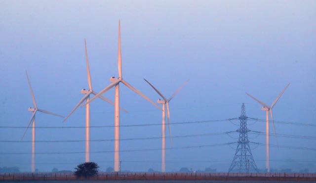 Sun illuminates wind turbines at Romney Marsh in Kent