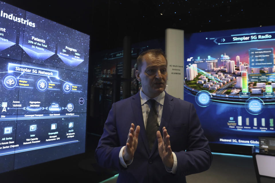 In this Aug. 19, 2019, photo, Richard Griffiths, a vice president in Huawei's consultant office, speaks during a tour of an exhibition promoting Huawei's 5G technologies at the Huawei Campus in Shenzhen in Southern China's Guangdong province. Facing a ban on access to U.S. technology, Chinese telecom equipment maker Huawei is showing it increasingly can do without American components and compete with Western industry leaders in pioneering research. (AP Photo/Ng Han Guan)