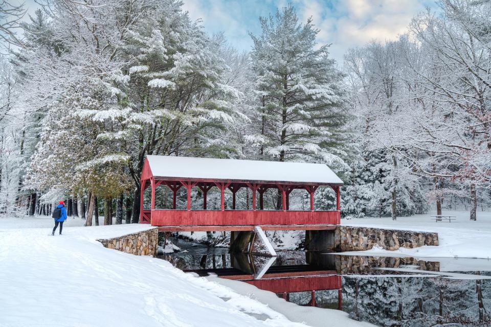 a red bridge over a river