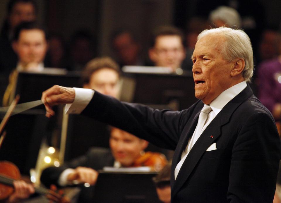 FILE - In this Jan. 1 2010 file photo, French Maestro Georges Pretre conducts the Vienna Philharmonic Orchestra accept applause from the audience during the traditional New Year's concert at Vienna, Austria. Pretre, who conducted renowned symphonies from Vienna to Milan's La Scala and New York's Metropolitan Opera and was instrumental in Maria Callas' opera career, has died. He was 92. (AP Photo/Lilli Strauss, File)