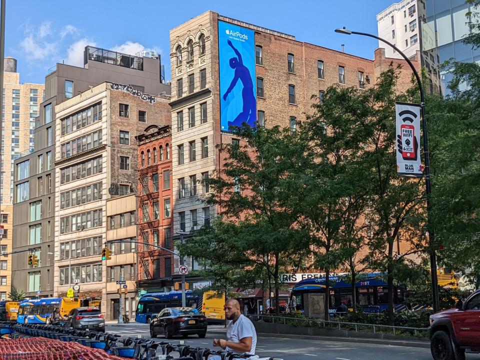 <p>A picture from the Pixel 6a's camera, featuring colorful NYC buildings. A blue banner hangs on the side of one of them.</p>
