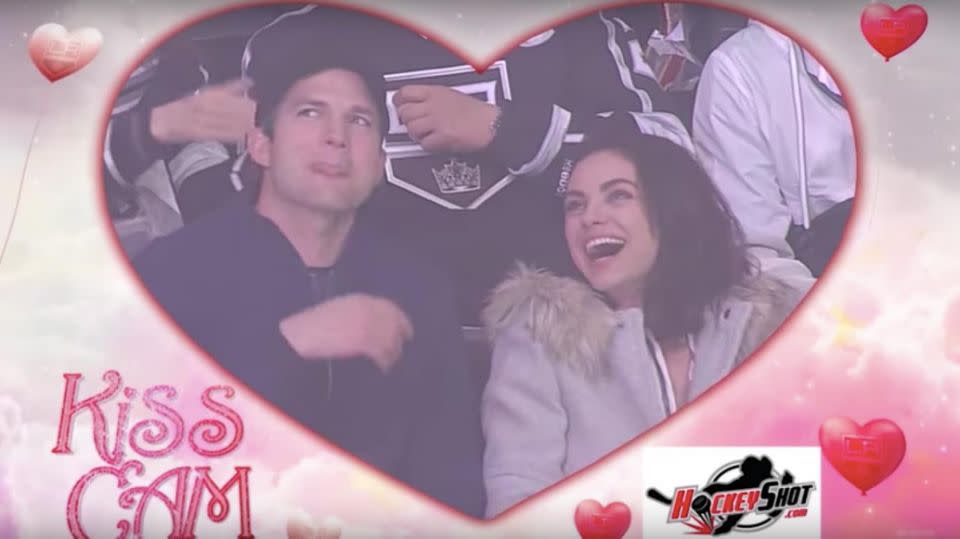 Ashton hilariously licked his lips in preparation to plant a big smooch on his wife. Source: YouTube / LA Kings