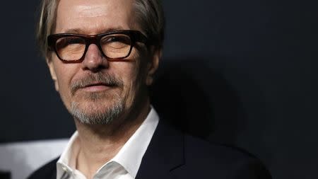 Actor Gary Oldman poses as he arrives for the Saint Laurent fall collection fashion show at the Hollywood Palladium in Los Angeles, California February 10, 2016. REUTERS/Mario Anzuoni/File Photo