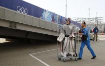 RNPS YEAR END 2014 - BEST OF SPORT ODDLY A volunteer pushes Switzerland's goaltender Sophie Anthamatten in a trolley as she leaves the Shayba Arena following a practice session ahead of the 2014 Sochi Winter Olympics, in this February 6, 2014 file photo. REUTERS/Phil Noble/Files (RUSSIA - Tags: SPORT ICE HOCKEY OLYMPICS TPX IMAGES OF THE DAY)