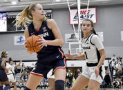 UConn's Dorka Juhász, left, grabs a rebound as Providence's Kylee Sheppard (1) watches during the second half of an NCAA college basketball game, Wednesday, Feb. 1, 2023, in Providence, R.I. (AP Photo/Mark Stockwell)