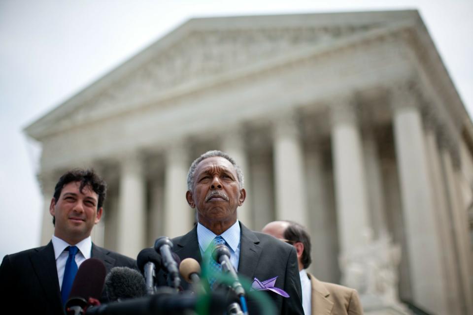 Otis McDonald, center, lead plaintiff, speaks at a news conference with his legal team including Alan Gura, left, outside the U.S. Supreme Court building after the announcement of a ruling in their case seeking to overturn Chicago's ban on handguns on June 28, 2010, in Washington. The court overturned the ban, a victory for McDonald and gun rights groups such as the National Rifle Association.