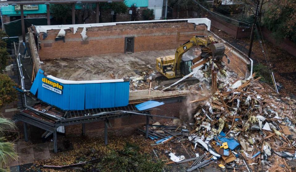 An excavator demolishes the Dimple Records site, once the heart of the Tower Records retail music franchise, at Broadway and Land Park Drive in 2019.