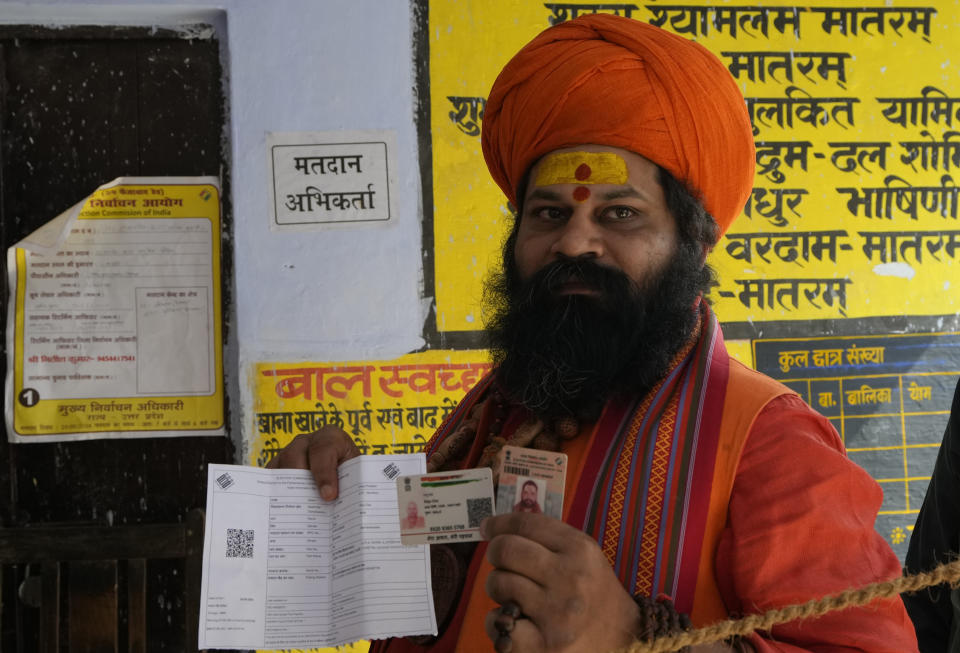 An Indian Hindu holy man shows his finger marked with indelible ink after casting his vote during the fifth round of multi-phase national elections outside a polling station in Ayodhya, India, Monday, May 20, 2024. (AP Photo/Rajesh Kumar Singh)