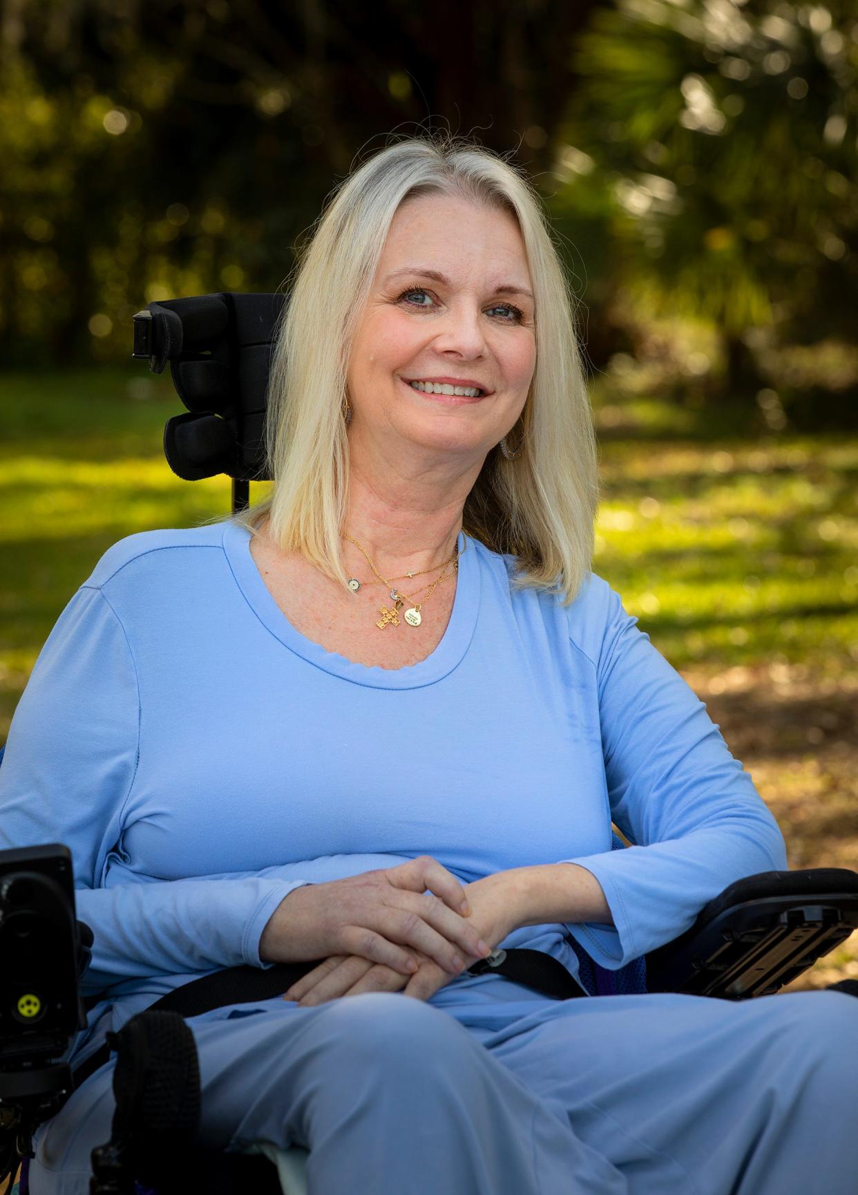 Laura Pinner sits in the backyard of her family's home in South Lakeland. Pinner, 53, was diagnosed two years ago with ALS. She is no longer able to lift her hands but still manages to control her power wheelchair and use her cell phone.