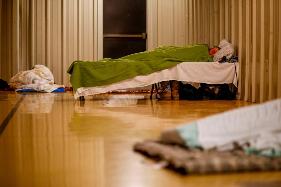 In this 2019 file photo, Clients of Room at the Inn watch television, stretch out on cots, and get a nights rest during their stay at New St. Luke Baptist Church in Jackson.