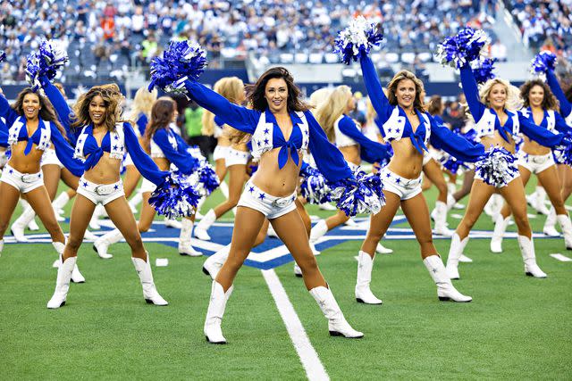 <p>Wesley Hitt/Getty</p> Dallas Cowboy cheerleaders perform before a game against the Chicago Bears at AT&T Stadium on October 30, 2022 in Arlington, Texas.