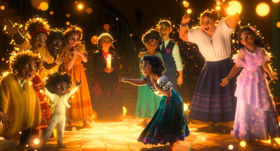 Mirabel (voiced by Stephanie Beatriz, center) is the only ordinary child of the magical Madrigal family in Disney's musical "Encanto."