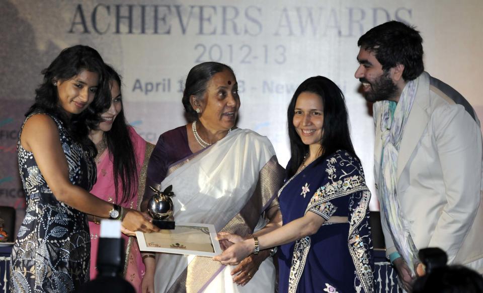 NEW DELHI, INDIA - APRIL 10: Rajasthan Governor Margaret Alva (C) along with YFLO Chairperson Divya Suri Singh (2 L), Zarin Daruwala (2 R) President ICICI Bank present award to Mitali Raj (L) for her contribution in field of Sports as during the FICCI  Ladies Organization Awards 2012-2013 on April 10, 2013 in New Delhi, India. ( Photo By Sonu Mehta/Hindustan Times via Getty Images)
