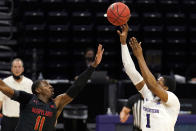 Northwestern guard Chase Audige, right, shoots over Maryland guard Darryl Morsell during the second half of an NCAA college basketball game in Evanston, Ill., Wednesday, March 3, 2021. Northwestern won 60-55.(AP Photo/Nam Y. Huh)