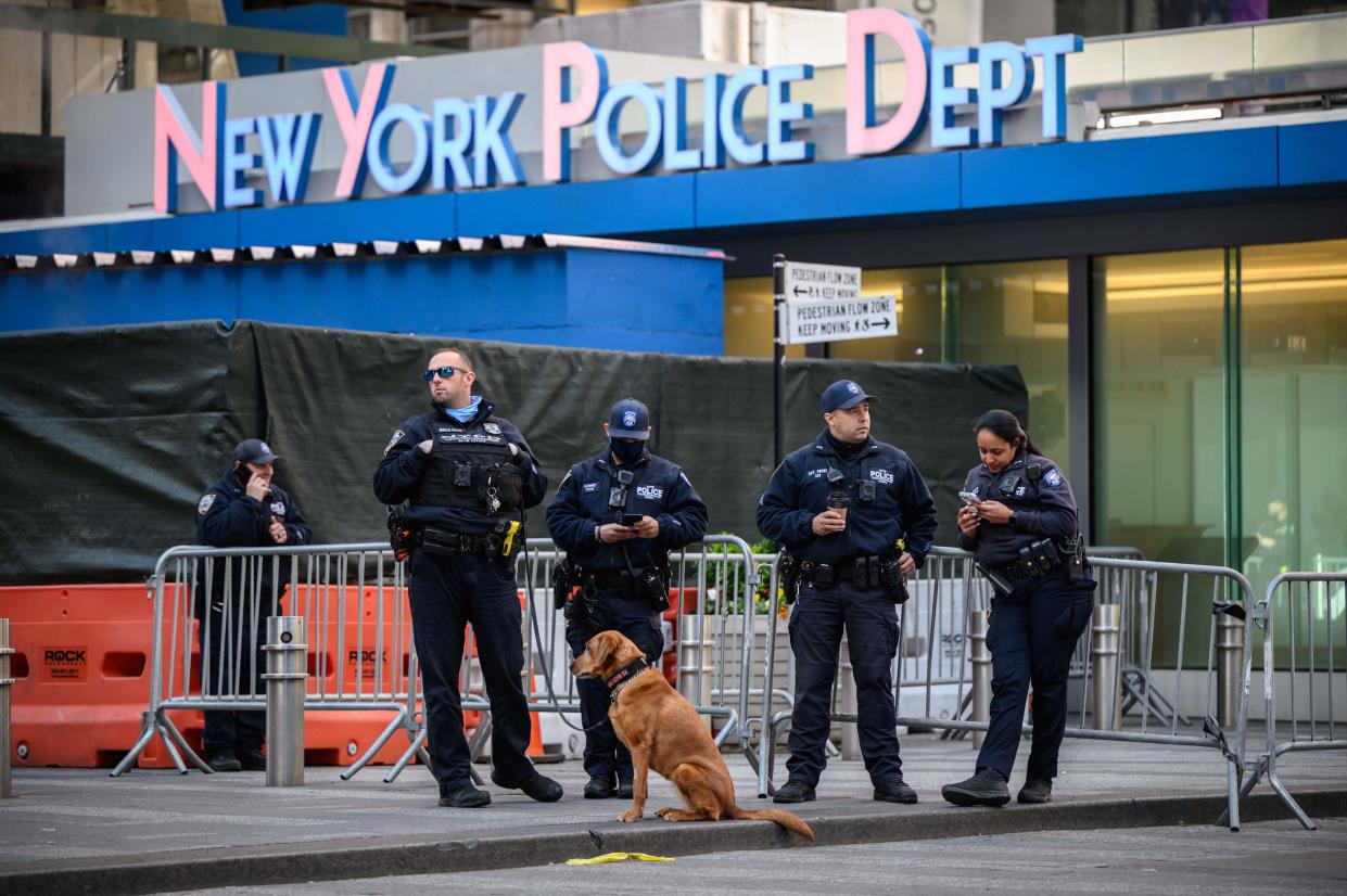 Police officers standing outside the Times Square police station.  (AFP via Getty Images)