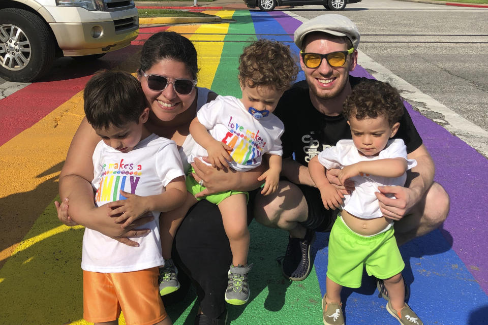 In this undated photo provided by Zahrah Wattier, Wattier, back left, a high school teacher, poses for a photo with her husband, her 4-year-old and 2-year-old twins in Galveston, Texas. As the Trump administration pushes full steam ahead to force schools to resume in-person education, public health experts warn that a one-size-fits-all reopening could drive infection and death rates even higher. Her district had been considering options many others are reviewing: in-person education, full-time online teaching and a hybrid mix. (Courtesy of Zahrah Wattier via AP)