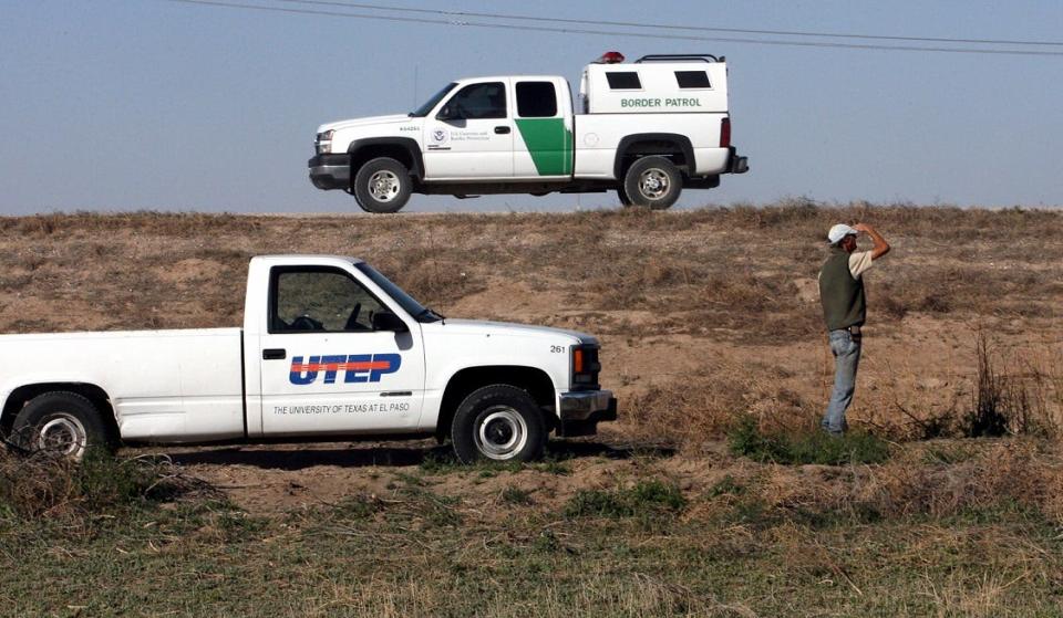 April 13, 2008: John Spraul, right, manager of the Rio Bosque Wetlands Park in far East El Paso looked out along the West end of the park as a US Border Patrol vehicle passed along a border levee road. A proposed 15 to 18-foot high border fence would be built between Sproul and the Border Patrol vehicle.