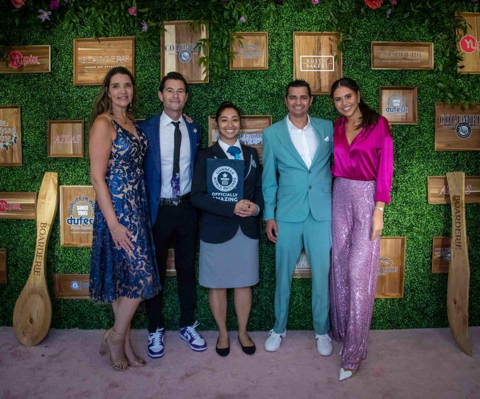 Guinness World Records adjudicator, Chrissy Fernandez, center, poses for a photo with the co-owners of Boarderie (from left) Julie Menitoff, Aaron Menitoff, Angel Jerez, and Rachel Solomon, at The Colony Hotel. Boarderie, a successful Shark Tank brand based in Riviera Beach, broke the world record title for the largest charcuterie board.