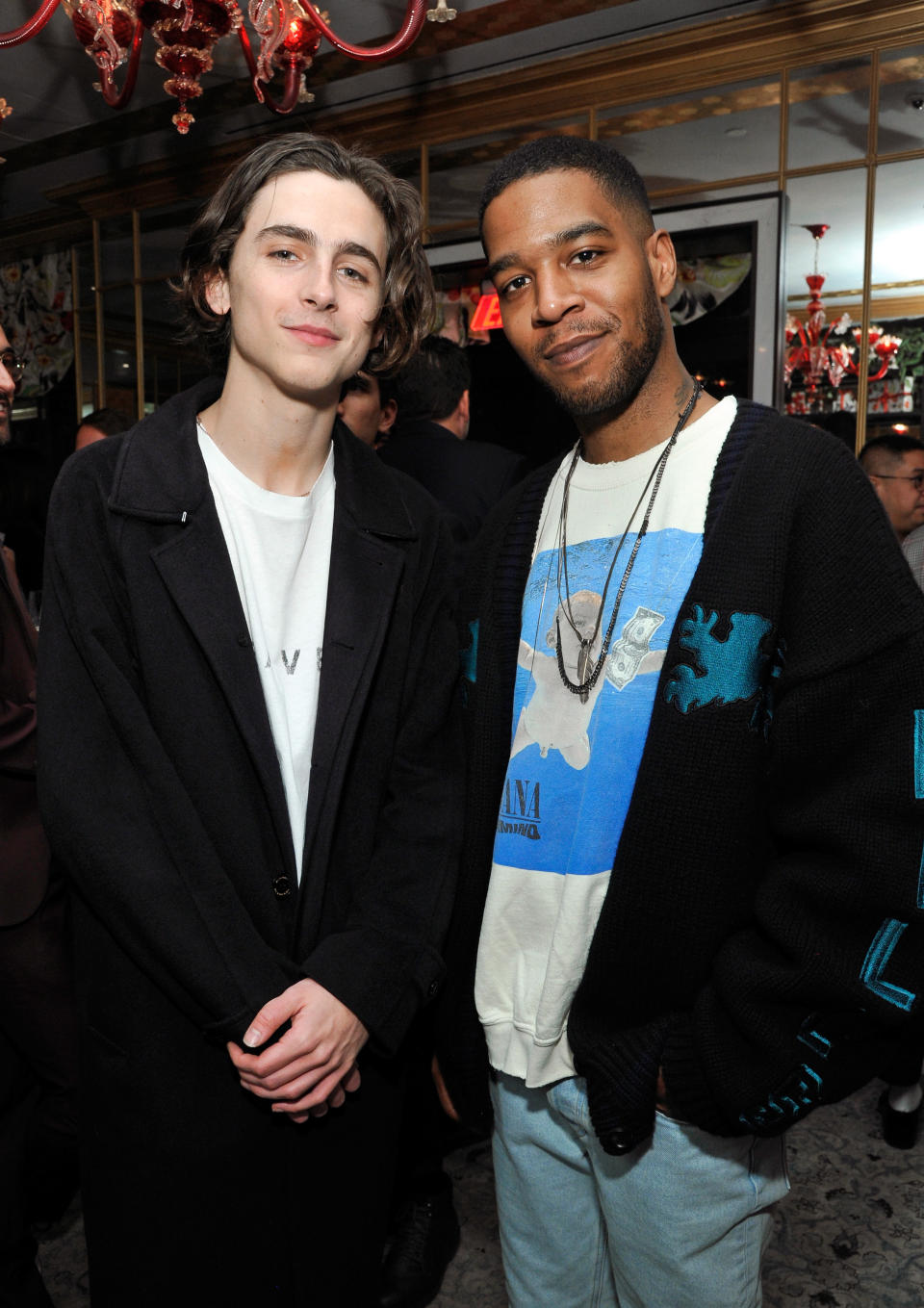 Timothée Chalamet and Kid Cudi pose at a GQ dinner to celebrate the magazine's March cover  in 2018