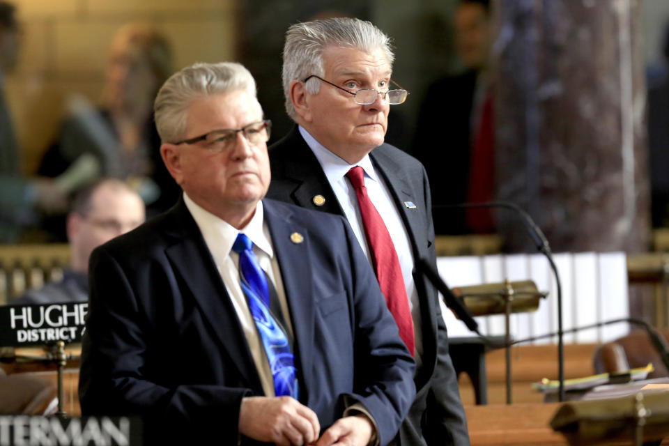 In this March 13, 2018 photo, Nebraska state Sens. John Stinner of Gering, right, and Mark Kolterman of Seward follow debate in the Legislative Chamber in Lincoln, Neb. Faced with the possibility that Neb. voters might approve a ballot measure expanding Medicaid, Stinner says he does not want to be insensitive to people in that Medicaid expansion group, but he does not think it is sustainable. Kolterman does not believe anybody (in the Legislature) who voted against extending Medicaid is really opposed to helping people, but wonders how the state is going to pay for it. (AP Photo/Nati Harnik)