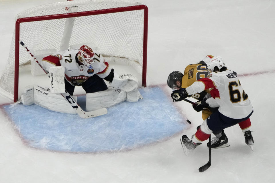 Vegas Golden Knights left wing William Carrier (28) scores on Florida Panthers goaltender Sergei Bobrovsky (72) during the third period of an NHL hockey game Thursday, Jan. 12, 2023, in Las Vegas. (AP Photo/John Locher)