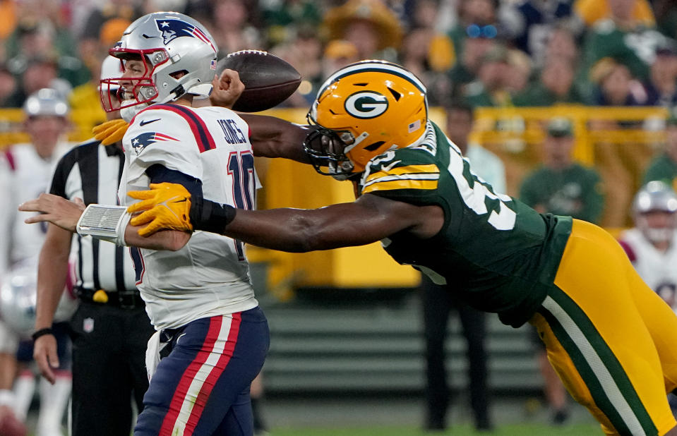 Aug 19, 2023; Green Bay, WI, USA; Green Bay Packers linebacker Kingsley Enagbare (55) forces a fumble by New England Patriots quarterback <a class="link " href="https://sports.yahoo.com/nfl/players/33403" data-i13n="sec:content-canvas;subsec:anchor_text;elm:context_link" data-ylk="slk:Mac Jones;sec:content-canvas;subsec:anchor_text;elm:context_link;itc:0">Mac Jones</a> (10) during the second quarter of their preseason game at Lambeau Field. Mandatory Credit: Mark Hoffman-USA TODAY Sports