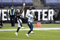 Tennessee Titans safety Amani Hooker (37) prepares to intercept a pass from Baltimore Ravens quarterback Lamar Jackson, not visible, intended for wide receiver Devin Duvernay (13) during the second half of an NFL football game, Sunday, Nov. 22, 2020, in Baltimore. (AP Photo/Gail Burton)