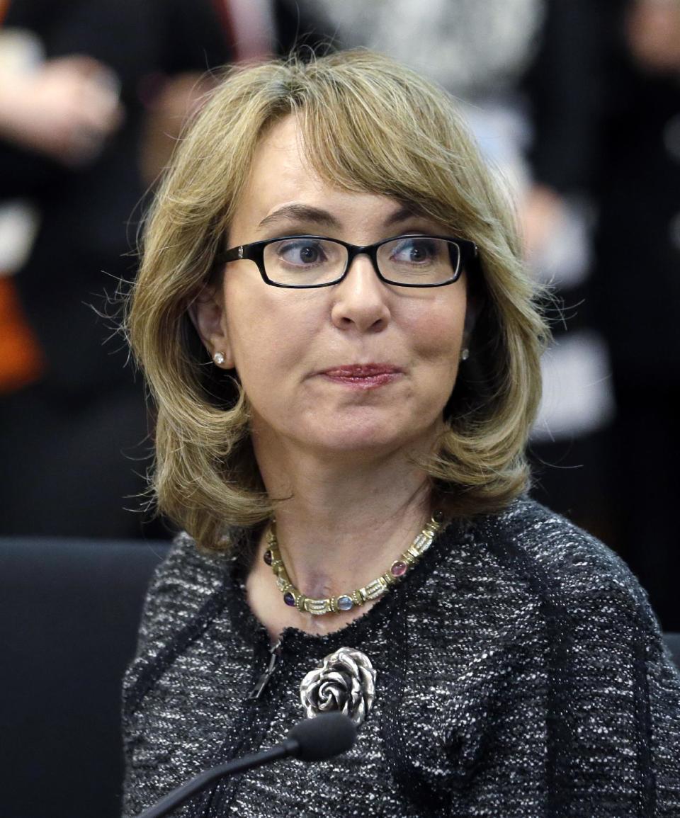 FILE - In this Jan. 28, 2014 file photo, former Arizona Congresswoman Gabrielle Giffords testifies before a Washington state House panel in Olympia, Wash. Jared Lee Loughner carried out the shooting rampage in Tucson that killed six people and wounded Giffords and 12 others on Jan. 8, 2011. Newly released law enforcement documents show how Loughner was unraveling in the month before the rampage, including issuing paranoid, expletive-filled Internet rants about killing and the government. The FBI released the documents Thursday, April 10, 2014, in response to media requests for the investigative files into the shooting. (AP Photo/Elaine Thompson)