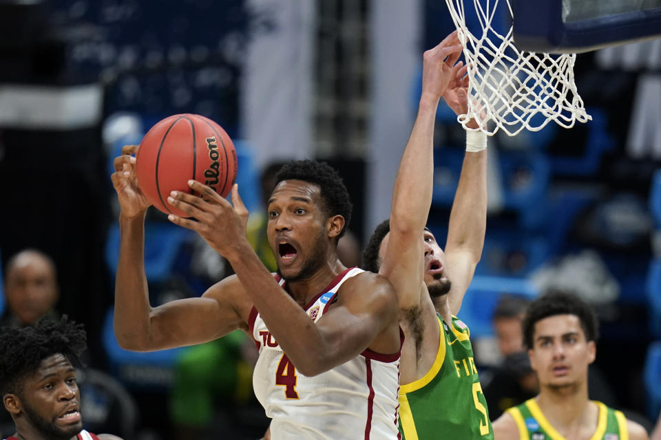 Southern California forward Evan Mobley (4) grabs a rebound in front of Oregon guard Chris Duarte (5) during the first half of a Sweet 16 game in the NCAA men's college basketball tournament at Bankers Life Fieldhouse, Sunday, March 28, 2021, in Indianapolis. (AP Photo/Jeff Roberson)