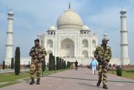 Central Industrial Security Force personnel patrol at the historic Taj Mahal premises in Agra