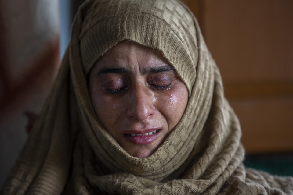 Rafiqa Banoo, mother of 16-year-old Athar Mushtaq, breaks down while talking to Associated Press in Bellow, south of Srinagar, Indian controlled Kashmir, Tuesday, Jan. 5, 2021. On the last week of 2020, Indian government forces killed Athar and two other young men during a controversial gunfight on the outskirts of the Indian-controlled Kashmir’s main city. Police did not call them anti-India militants but “hardcore associates of terrorists." They later buried them at a graveyard in a remote mountainous tourist resort miles away from their ancestral villages. Athar was the latest Kashmiri to be buried in a far-off graveyard after Indian authorities in a new controversial policy in 2020 started to consign blood-soaked bodies of scores of Kashmiri suspected rebels to unmarked graves, denying the mourning families a proper funeral and a burial. (AP Photo/ Dar Yasin)