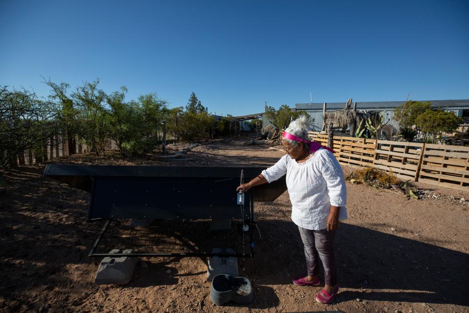 Olga Thomas uses water produced by the SOURCE Global hydro-panels on her property to fill her dog's water bowl in Hueco Tanks, Texas. Since moving to Hueco Tanks in the late 1990s, Thomas has waited for municipal water service to reach the neighborhood. May 23, 2023.