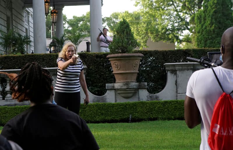 FILE PHOTO: A Picture and its Story: U.S. couple waves guns at anti-racism protesters