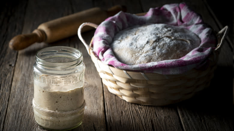 sourdough starter next to rising loaf