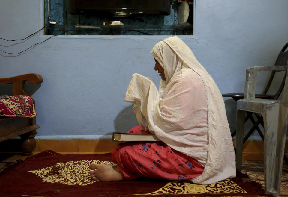 Nazima Shaikh, mother of Arbaz Mullah prays for her deceased son after offering evening prayers at her home in Belagavi, India, Oct. 7, 2021. Arbaz Mullah was a Muslim man in love with a Hindu woman. But the romance so angered the woman’s family that — according to police — they hired members of a hard-line Hindu group to murder him. It's a grim illustration of the risks facing interfaith couples as Hindu nationalism surges in India. (AP Photo/Aijaz Rahi)