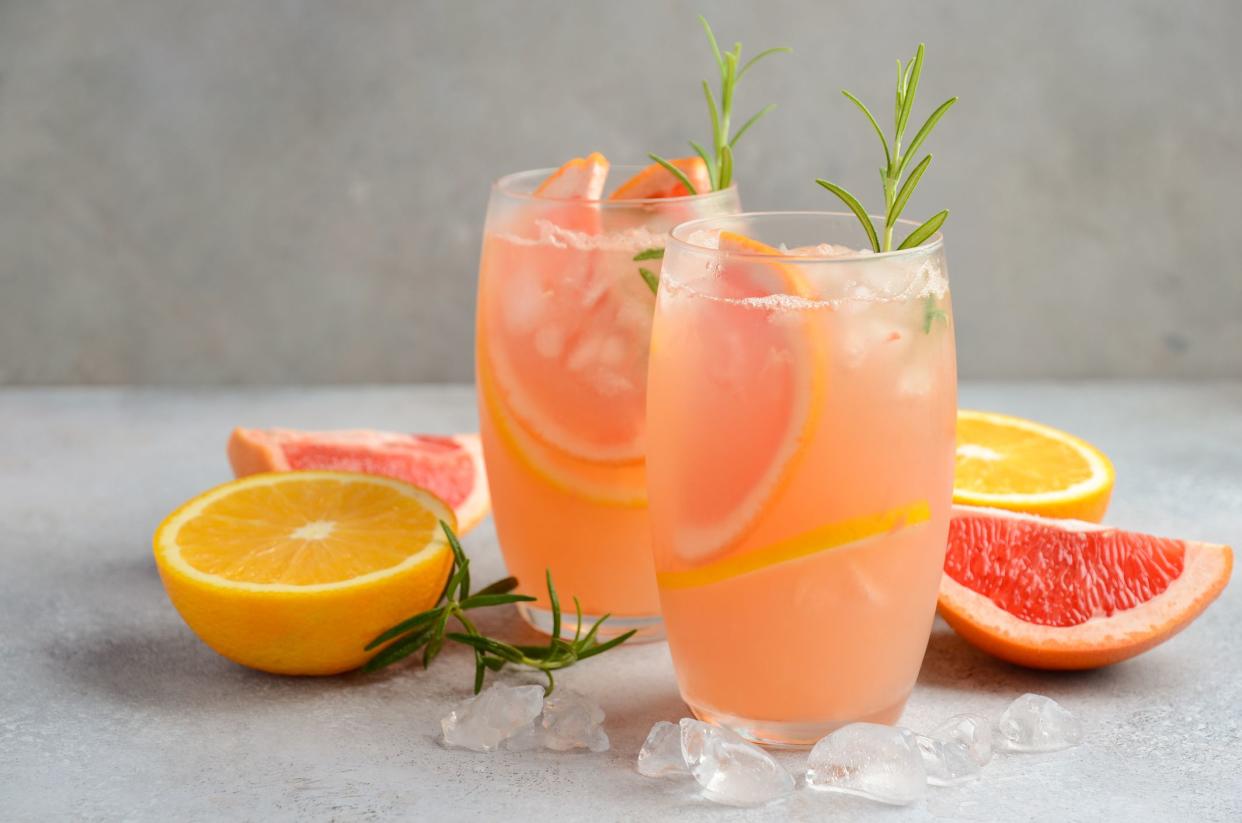 Refreshing citrus cocktail with grapefruit, orange and rosemary, selective focus