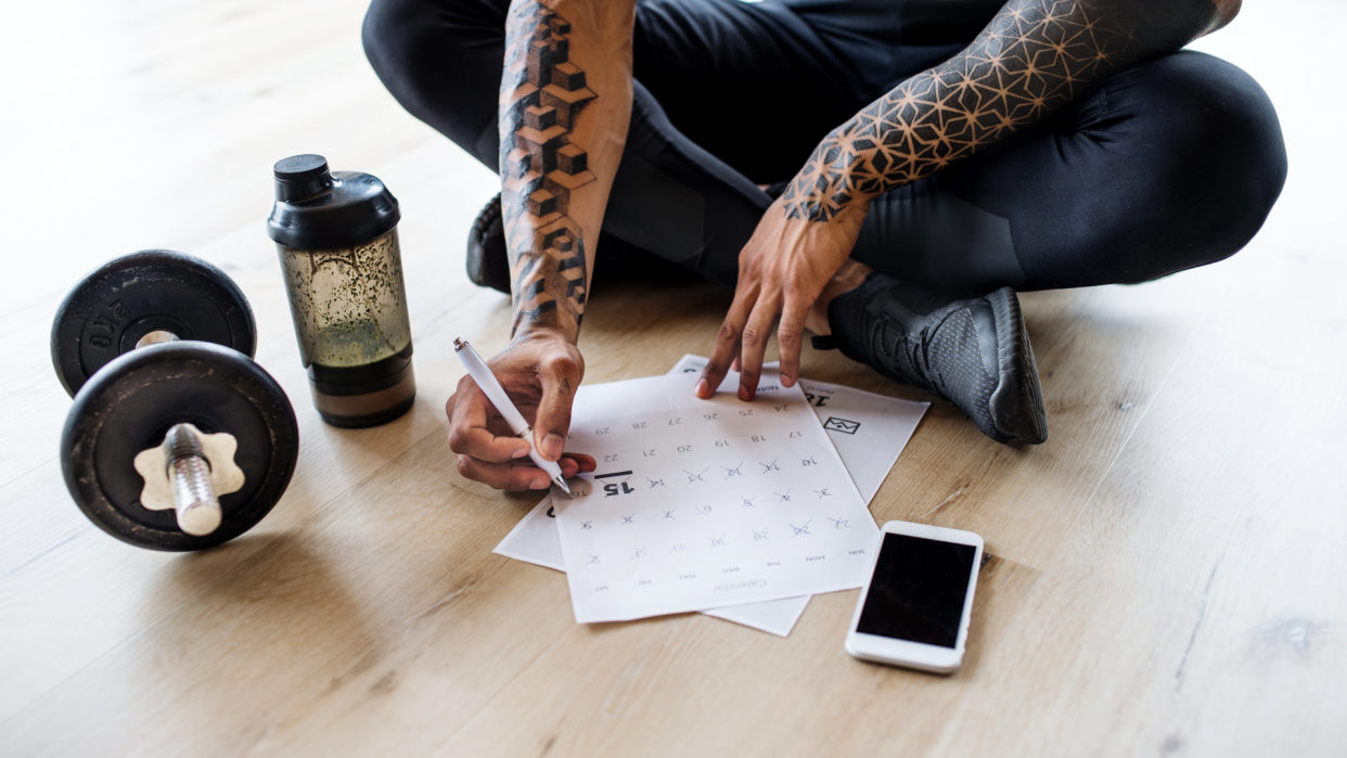  Person writing workout plan. 